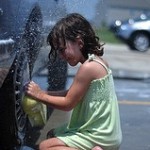 Small child washing the car