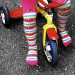 Girl with colorful stocking on tricycle